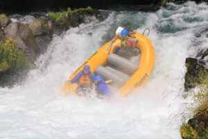 Raft going over waterfall on Washington state rafting trip