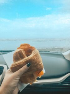 Enjoying a croissant on the Ocean Shores beach in the car