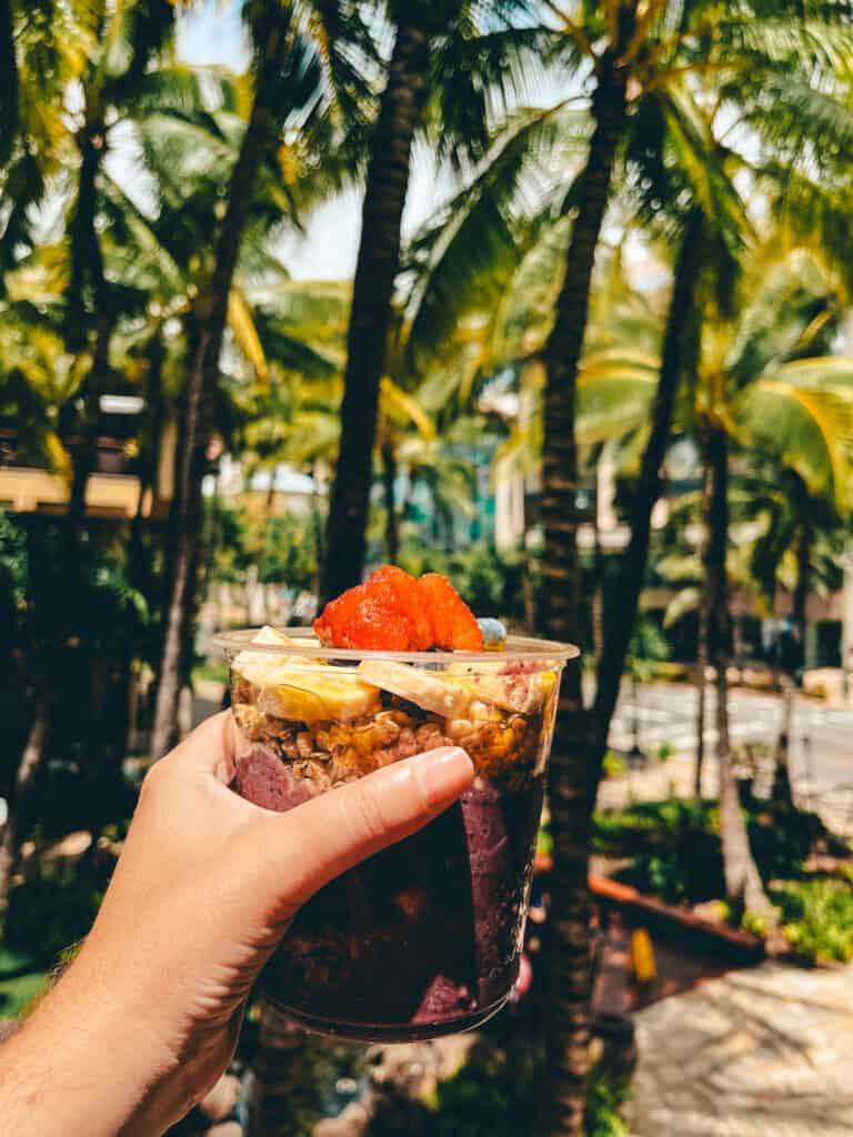 Acai bowl with palm trees in the background