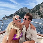 trev and chels travel couple on a boat  in italy