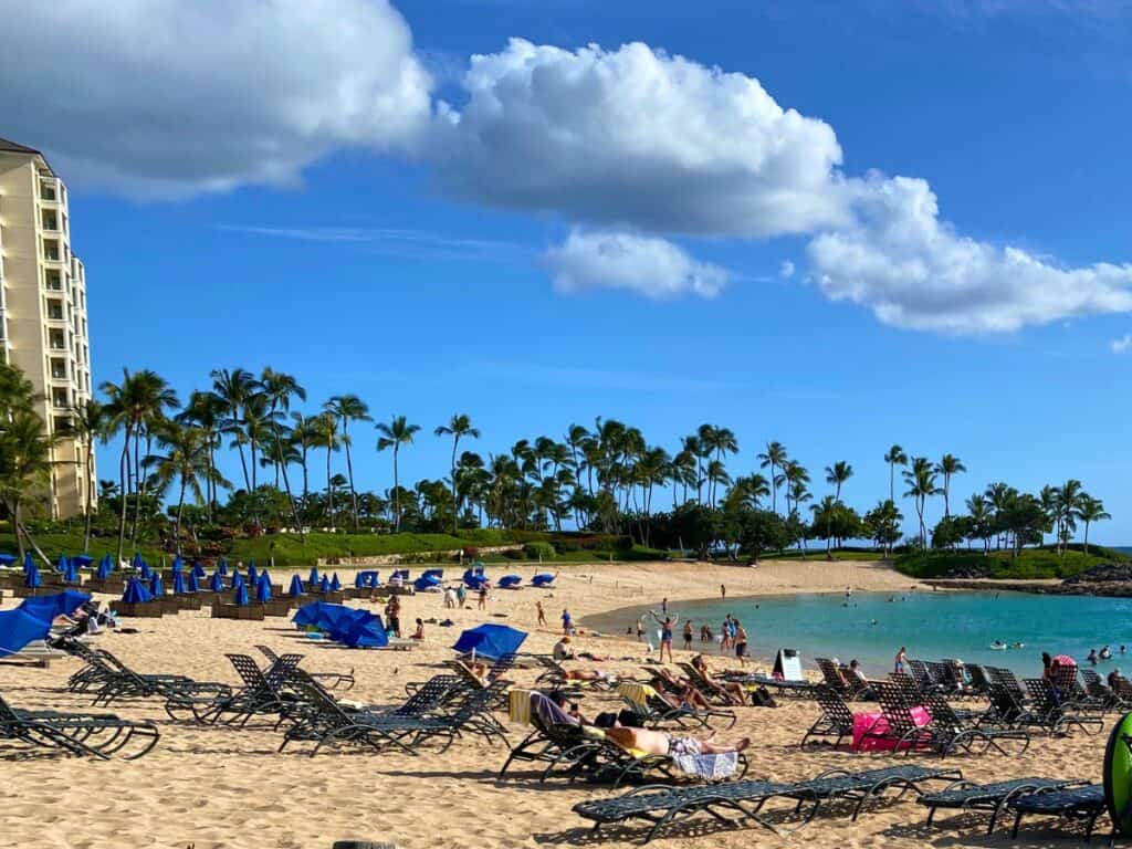 Beach at the Marriott Ko Olina with beach chairs and people laying out on the sand