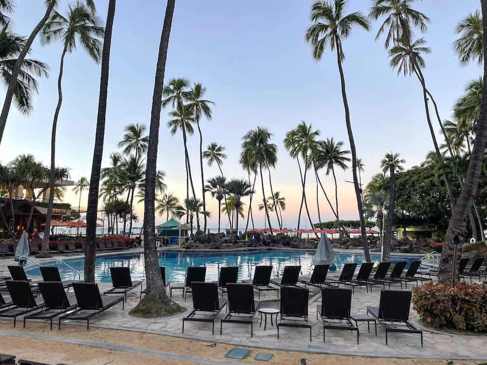 Pool at the hilton hawaiian villiage oahu with palm trees and the sunrise