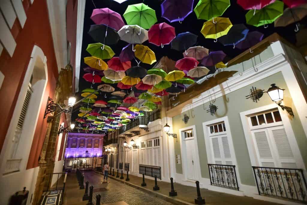 Assorted Coloured Umbrellas Hanging Near Buildings