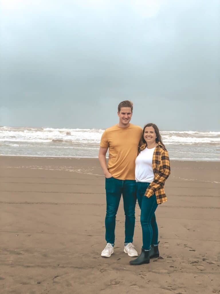 couple on the beach in ocean shores wearing yellow shirts