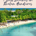 Promotional graphic for '7 Best Beaches in Roatan Honduras' featuring a vibrant image of a bustling beach scene with crystal blue waters, beachgoers, and lush greenery, with the text overlay and website 'THETRAVELINGMOORE.COM' at the bottom