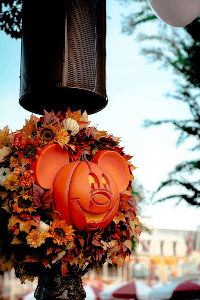 A pumpkin wreath with mickey mouse ears on it