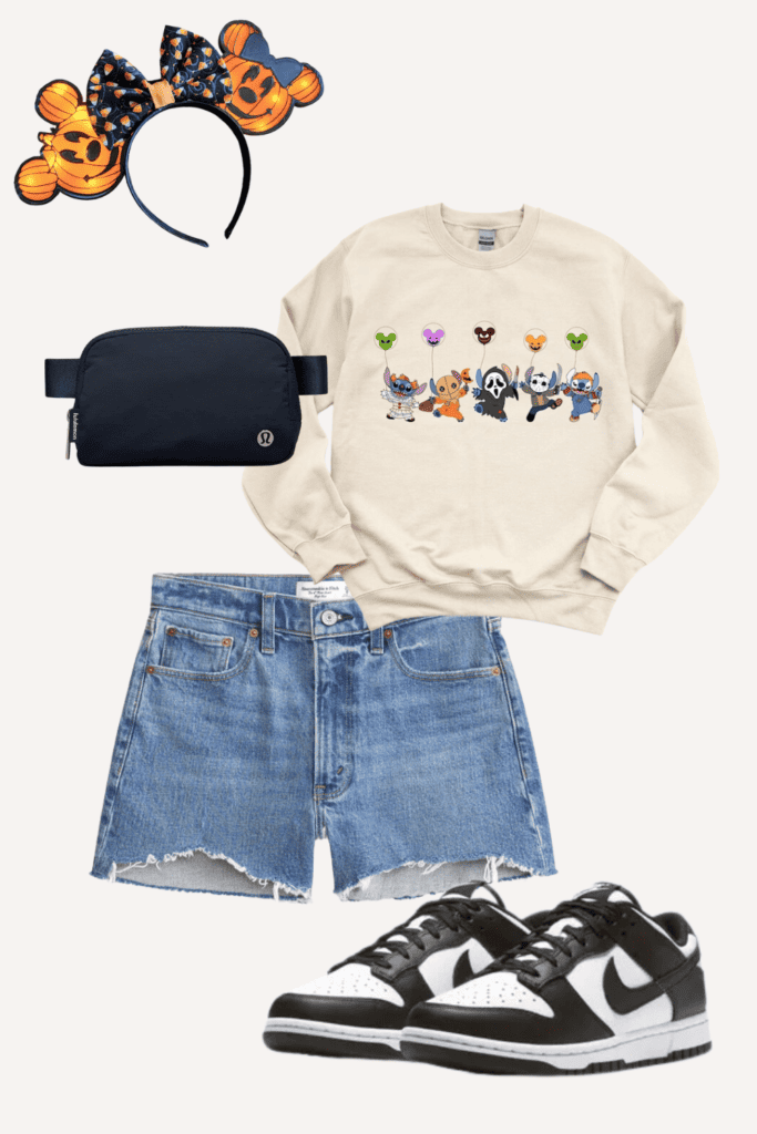 Casual outfit layout featuring Halloween-themed accessories and clothing. At the top is a pair of Halloween mouse ears headband with orange pumpkin designs. Below is a beige crew neck sweatshirt with a row of cartoon dogs dressed in various Halloween costumes. Accompanying these are denim cutoff shorts and black and white sneakers. A compact, black crossbody bag completes the ensemble.