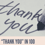 Close-up image of a handwritten note saying 'Thank you' with a marker pen, captioned with 'THANK YOU' IN 100 DIFFERENT LANGUAGES