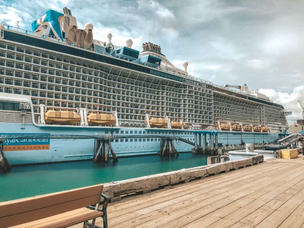 Majestic Royal Caribbean cruise ship docked in an Alaskan port, its massive decks and lifeboats on display