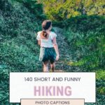 Image of a person in a white top and green shorts walking on a lush forest trail, with text overlay saying "140 Short and Funny Hiking Photo Captions" and the website "thetravelingmoore.com" at the bottom.