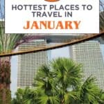 This image is a travel-themed graphic featuring the title "17 Hottest Places to Travel in January" in bold text. The background shows a view of Gardens by the Bay in Singapore, with the famous Supertree Grove and Marina Bay Sands hotel visible. The text is presented in contrasting dark grey and bright orange, while the website "thetravelingmoore.com" is displayed at the bottom. This visually appealing graphic is designed to attract readers looking for travel destinations in January.