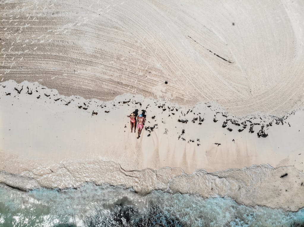 Bird's Eye View Of People Sitting On Beach